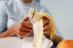 person Cut Banana 1292662472 770x533 1 650x428