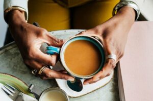 person Holding Coffee Cup Top View 1213479257 770x533 1 650x428