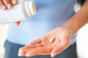 person taking viatamin supplement 1227007165 770x533 1 650x428