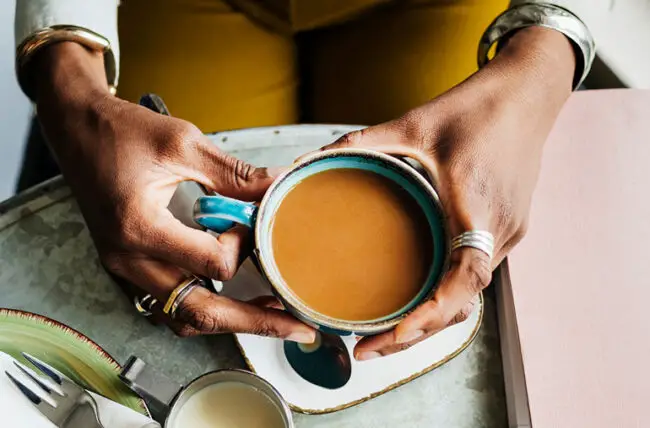 person Holding Coffee Cup Top View 1213479257 770x533 1