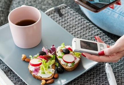 adult diabetic woman having breakfast home
