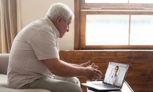 man using laptop telemedicine